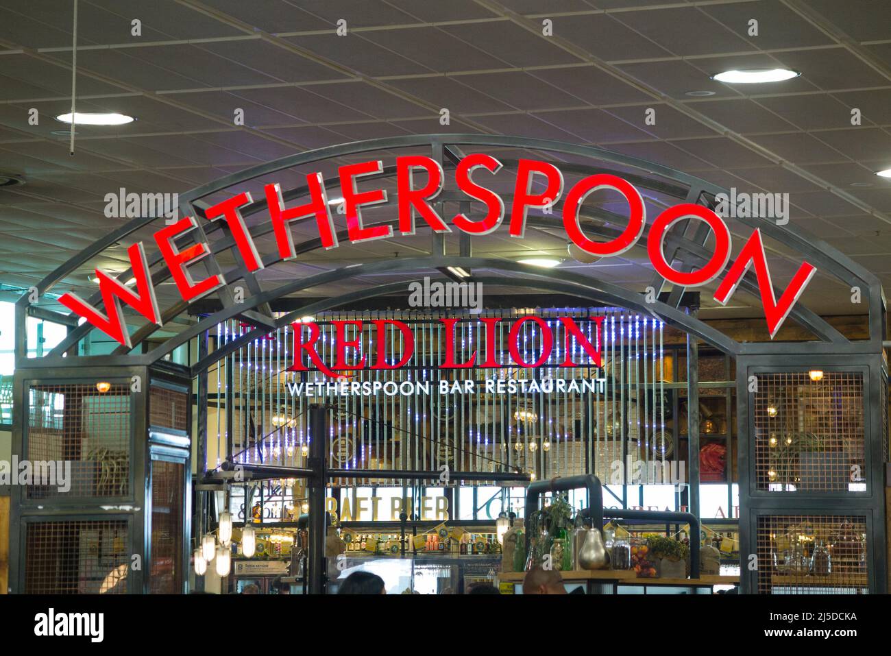 Sign / signage at The Red Lion Wetherspoon / Wetherspoons Pub / restaurant / Public House, at London Gatwick airport North Terminal, Crawley. UK (129) Stock Photo