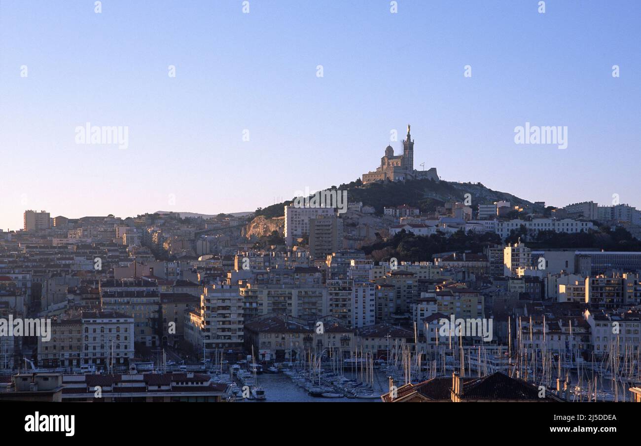 The old port of Marseille with the cathedral of Nd de la Garde in the background Stock Photo