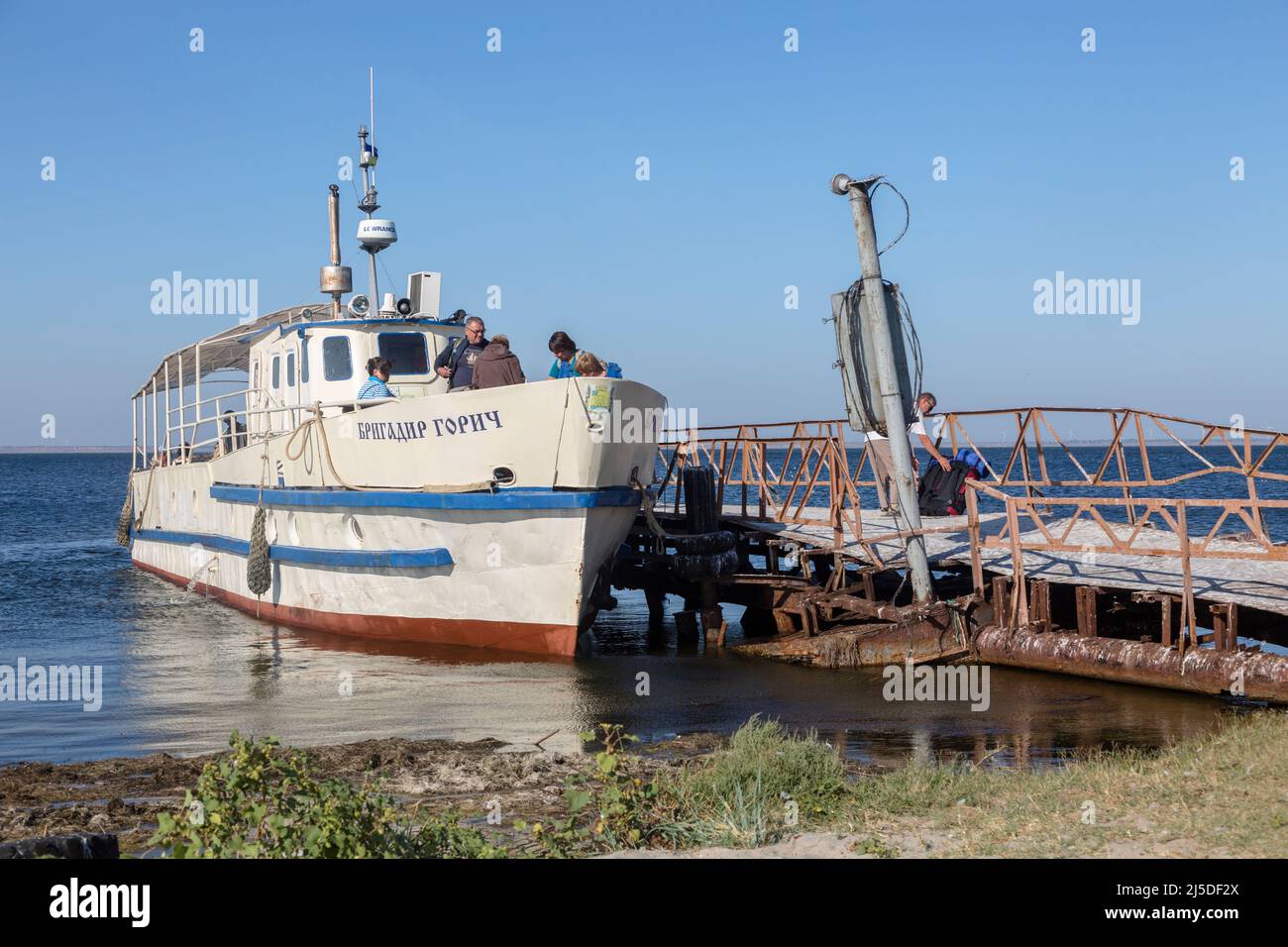 OCHAKIV, MYKOLAIV REGION, UKRAINE - SEPTEMBER 16, 2019: people are loaded on the civilian ship 'Brigadier Gorich' near the pier, Black Sea Stock Photo