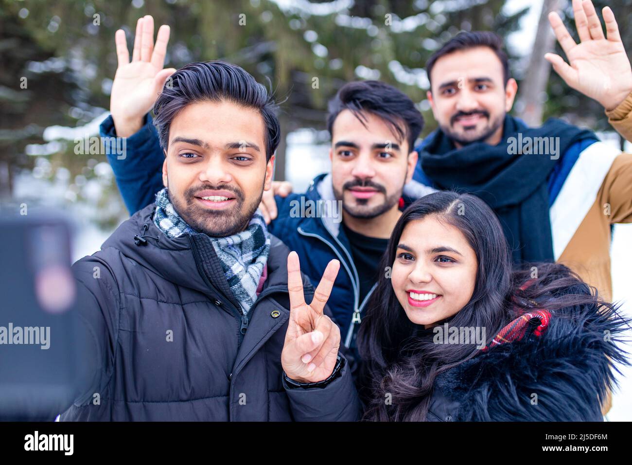 arabic guys having great time on Christmas holidays taking selfie photo on phone Stock Photo