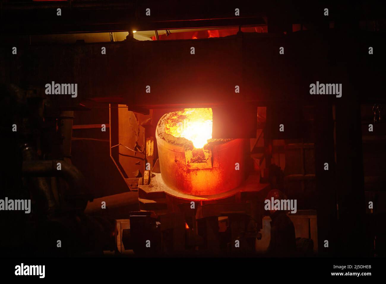 Worker operates metal casting process in metallurgical plant Stock Photo