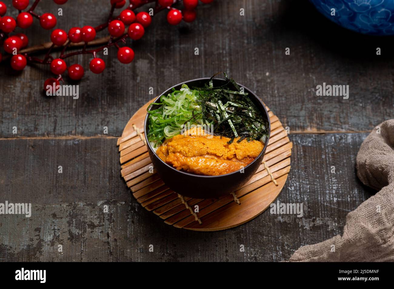 Sea Urchin Chawanmushi in a dish with chopsticks isolated on mat side view on wooden table taiwan food Stock Photo