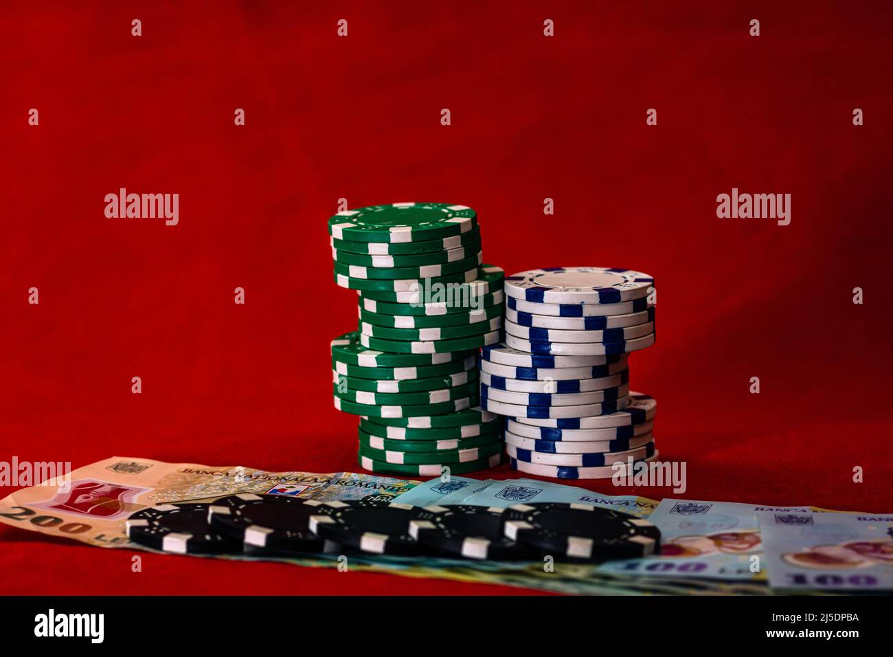 Stacks of poker chips with money on red background, Romanian LEI currency  Stock Photo - Alamy