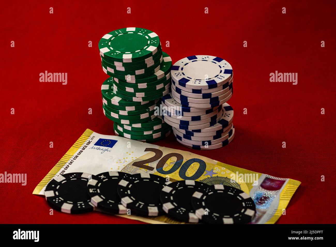 Stacks of poker chips with money on background, EURO currency Stock Photo