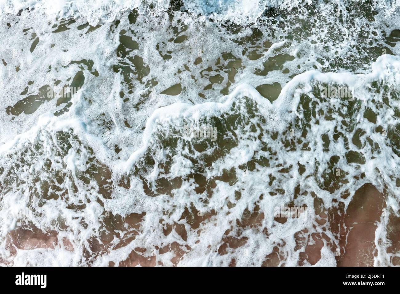 Sea water with waves and foam, top view, abstract natural background ...