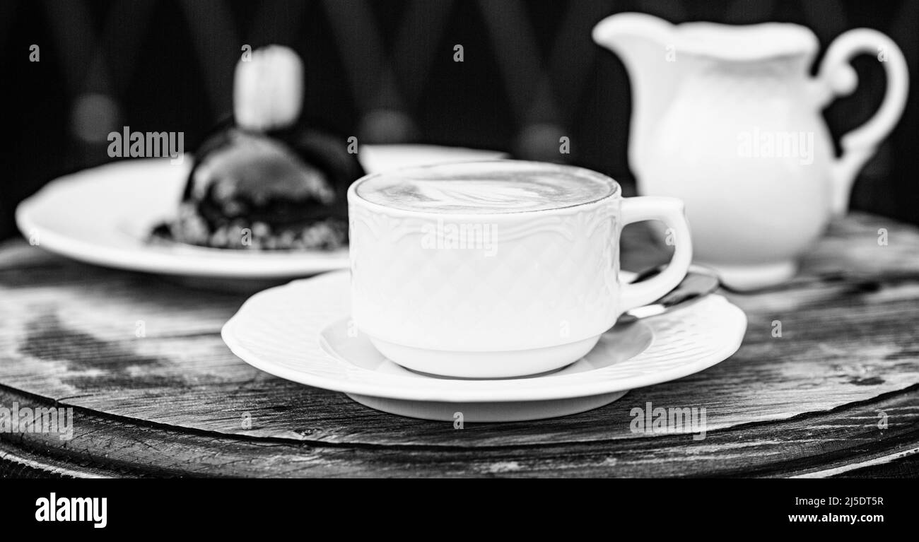 Loving coffee. Cup of fresh cappuccino. Chocolate cake. Cappuccino in a cup, hot latte, delicious coffee. Coffe time. Coffee or coffe cup at cafe in Stock Photo