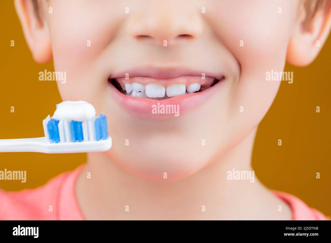 Dental hygiene. Happy little kid brushing her teeth. Kid boy brushing teeth. Boy toothbrush white toothpaste. Health care, dental hygiene. Joyful Stock Photo