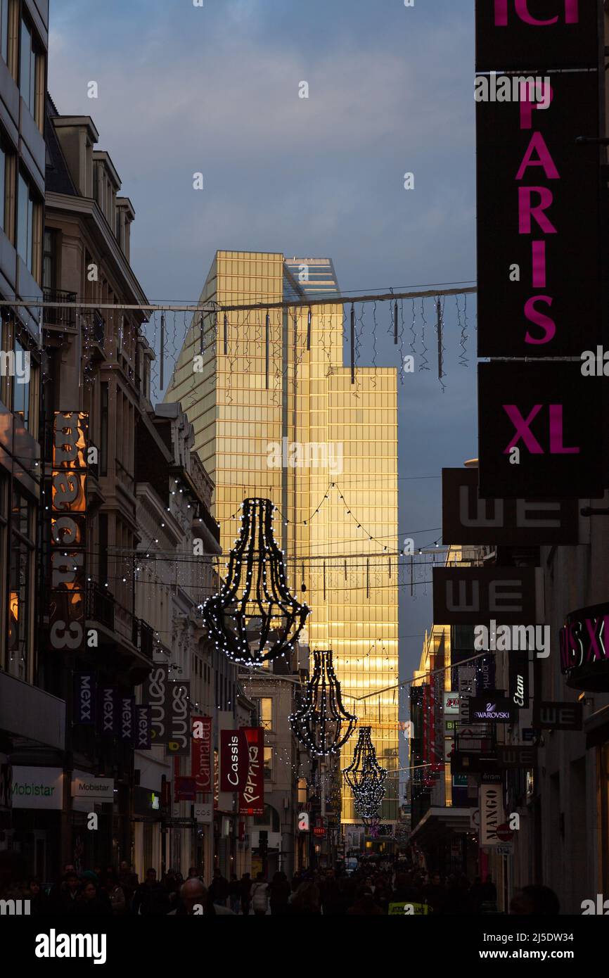 View of the Dexia tower, lit at sunset, in the extension of rue Neuve in the shade. Place Rogier, Brussels Stock Photo