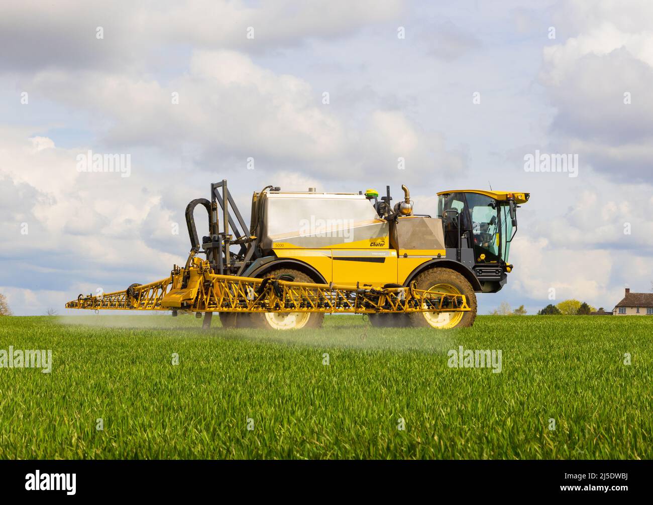 Farmer using a self propelled crop sprayer in a field in early spring. Hertfordshire, UK Stock Photo