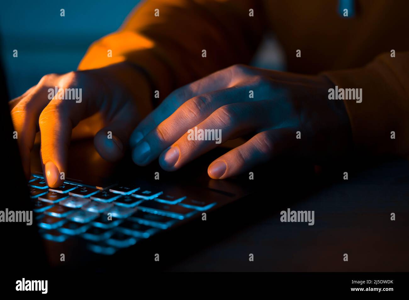 Hands types on a laptop keyboard. Stock Photo