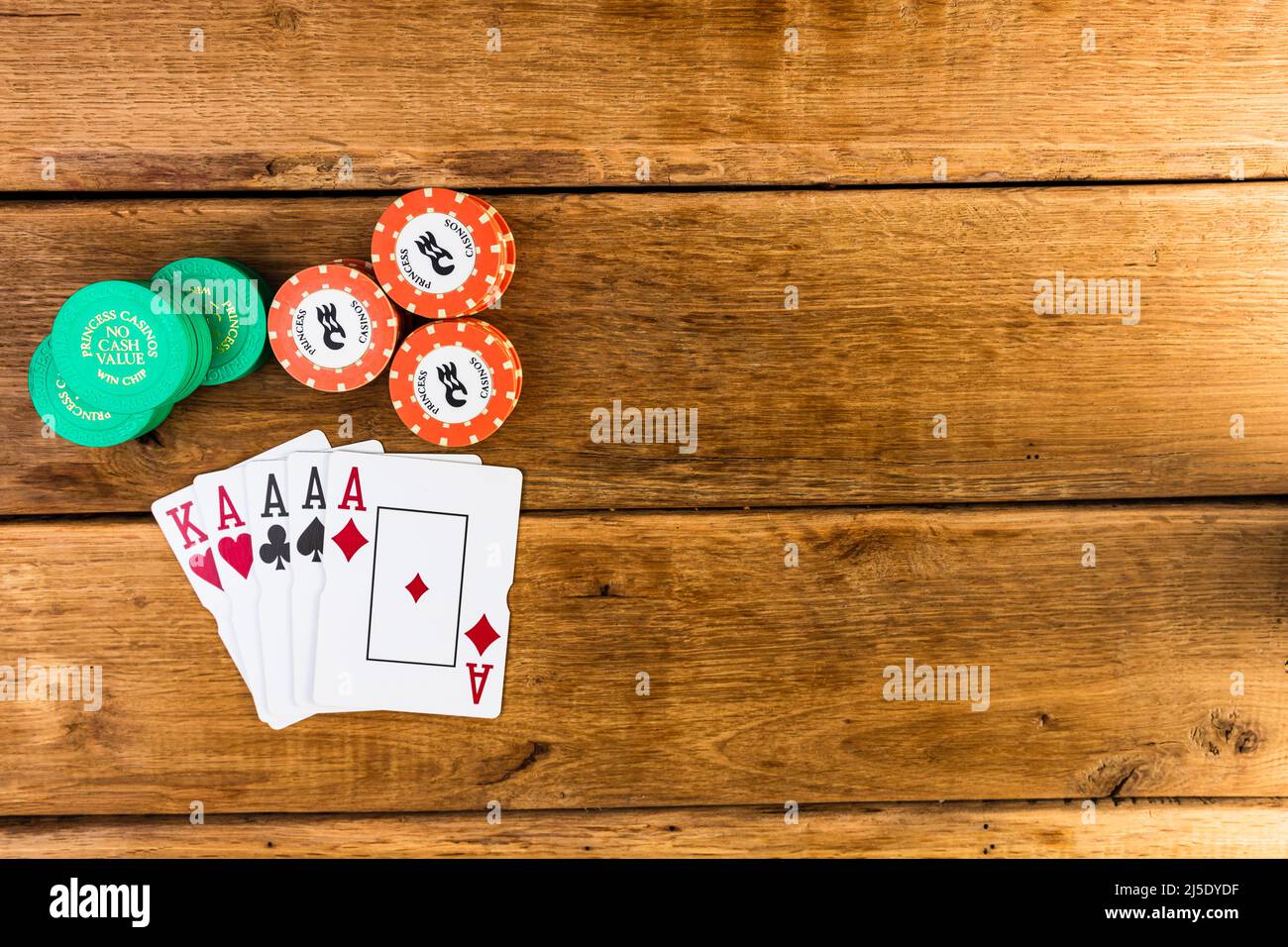 Stack of poker chips and aces on wooden background, poker chips spread