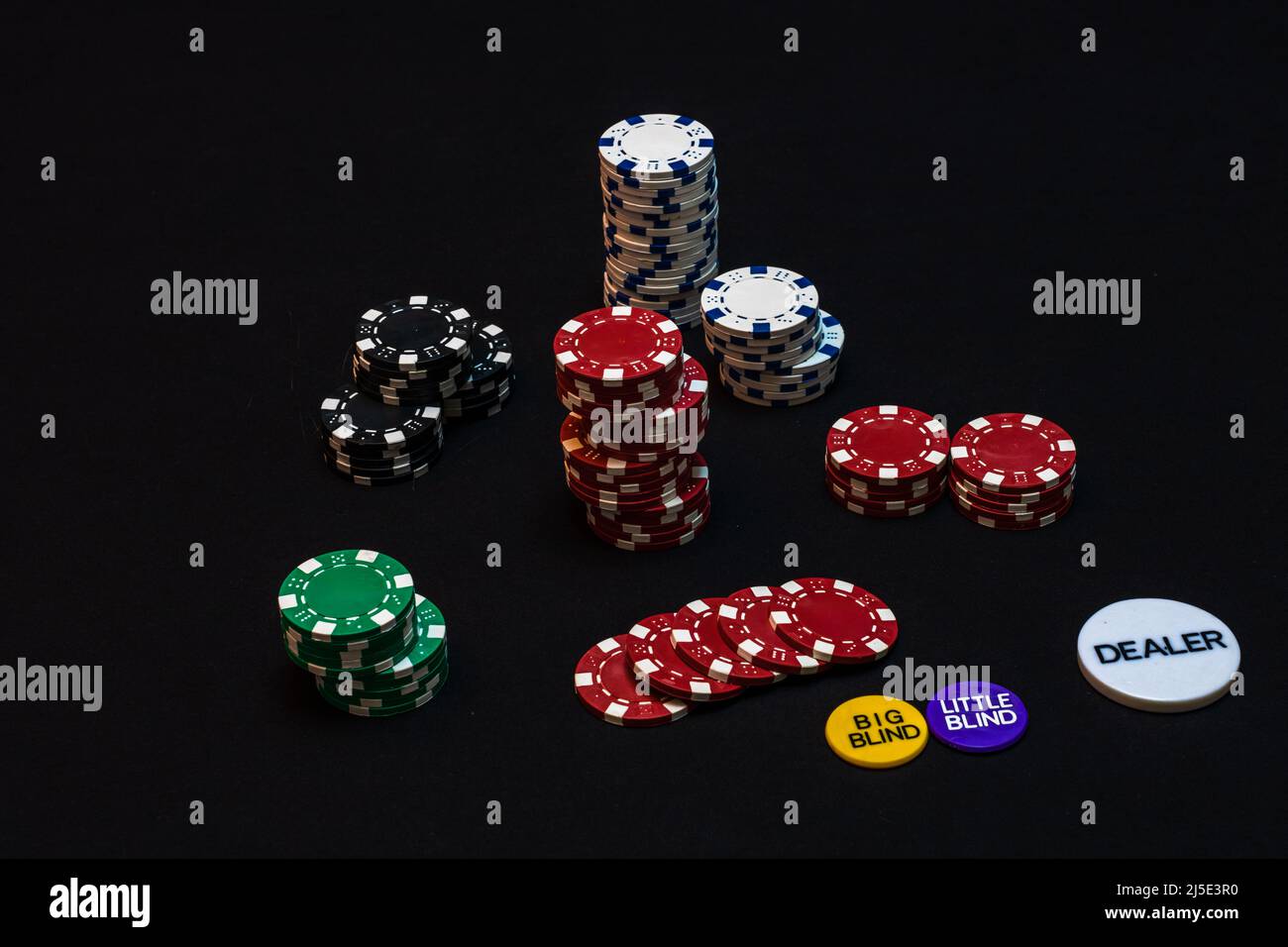 Stack of poker chips on black background, poker chips spread, big blind