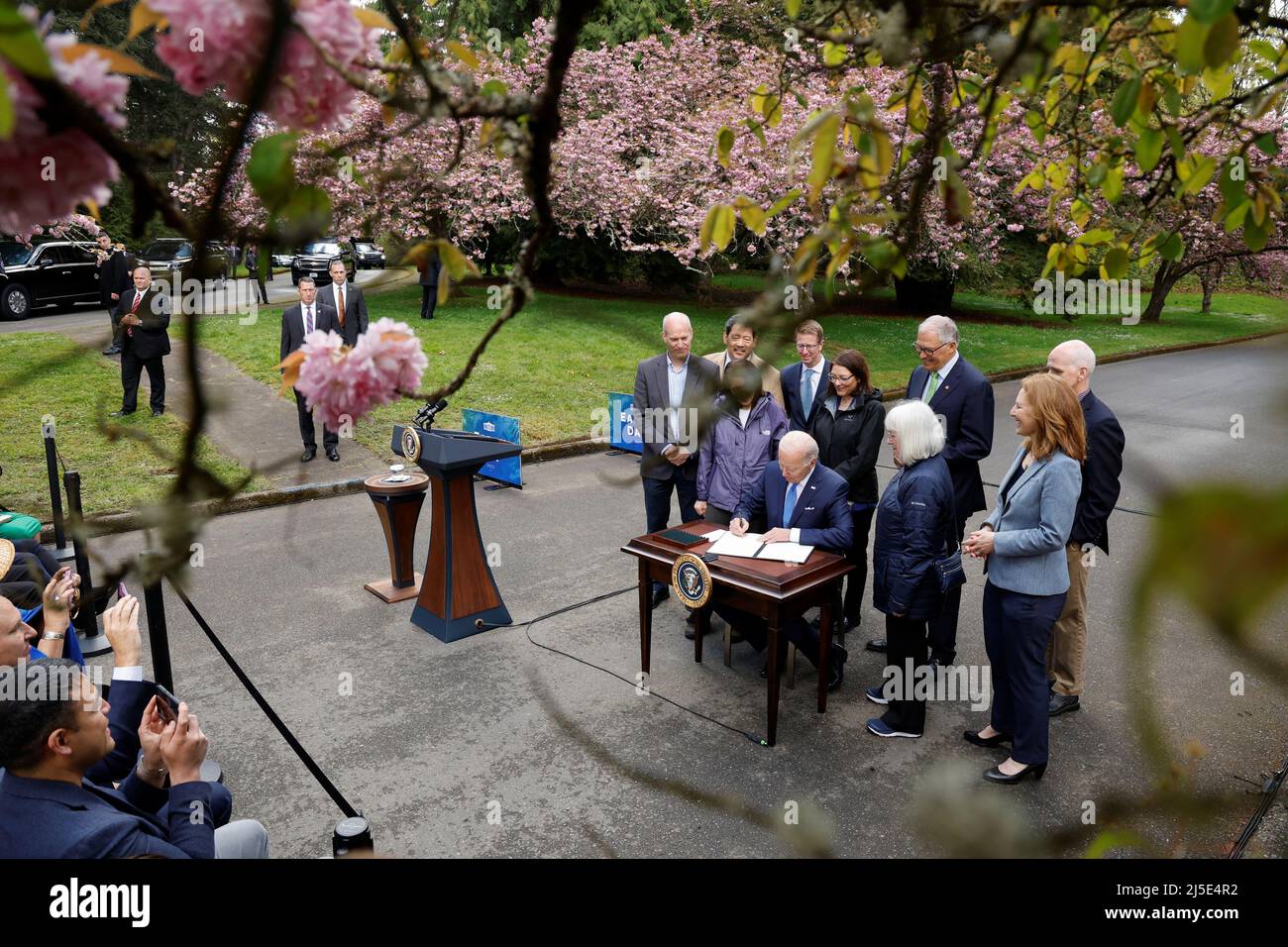 U.S. President Joe Biden signs an executive order intended as an initiative to conserve old-growth forests in federal lands, after delivering remarks about climate change and protecting national forests on Earth Day, at Seward Park in Seattle, Washington, U.S. April 22, 2022. REUTERS/Jonathan Ernst Stock Photo