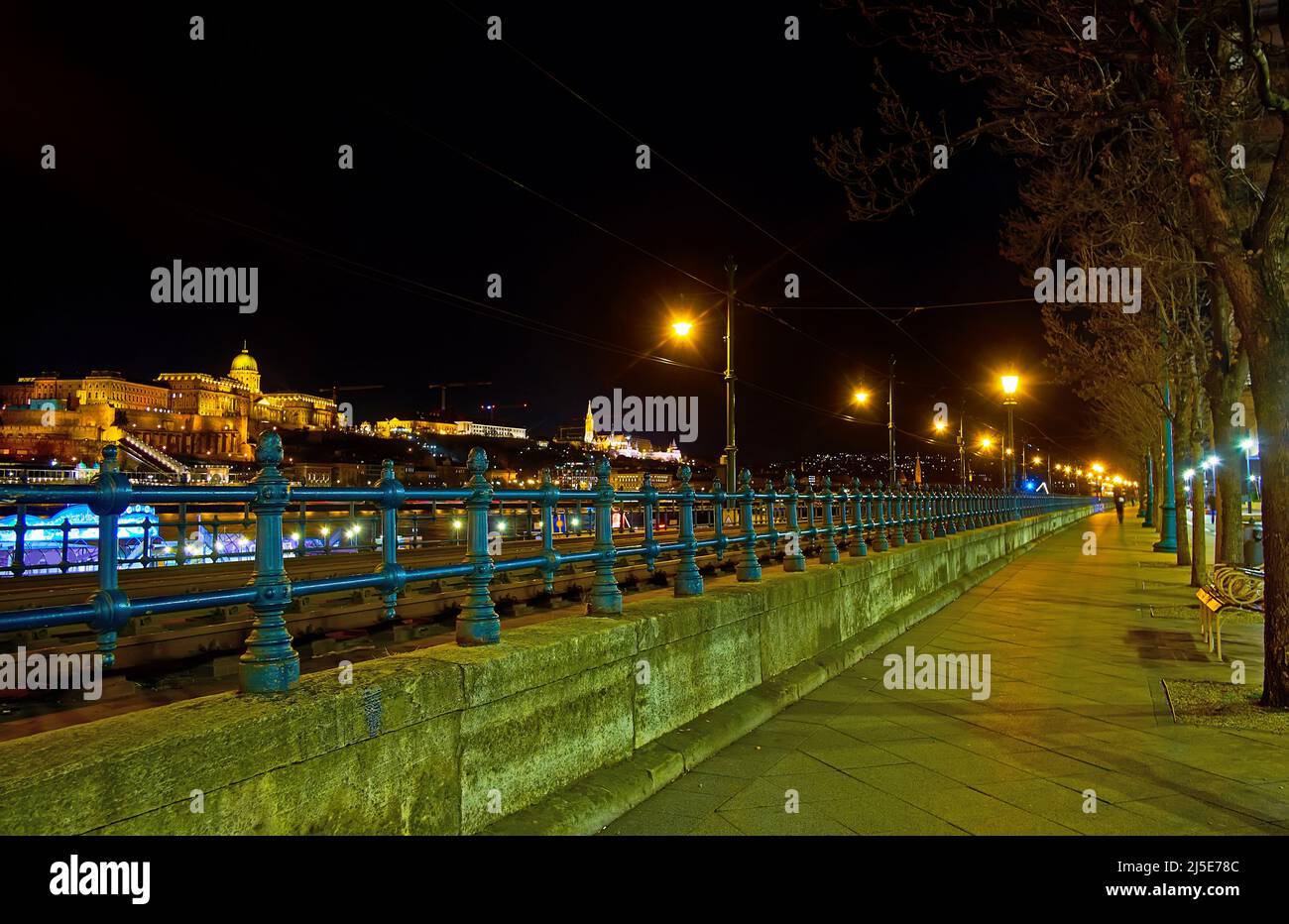 The bright illumination of Buda Castle, located atop the Castle Hill in Buda district, seen from embankment of Danube River in Pest district, Budapest Stock Photo