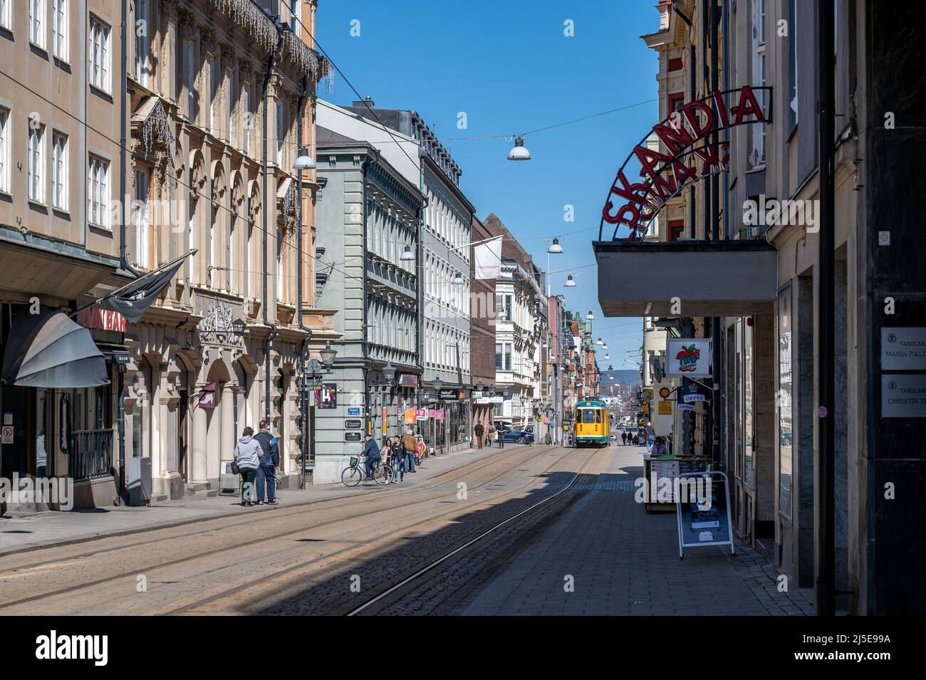 Tram on Drottningatan in the city center of Norrkoping, Sweden. The yellow trams are iconic for Norrkoping. Stock Photo