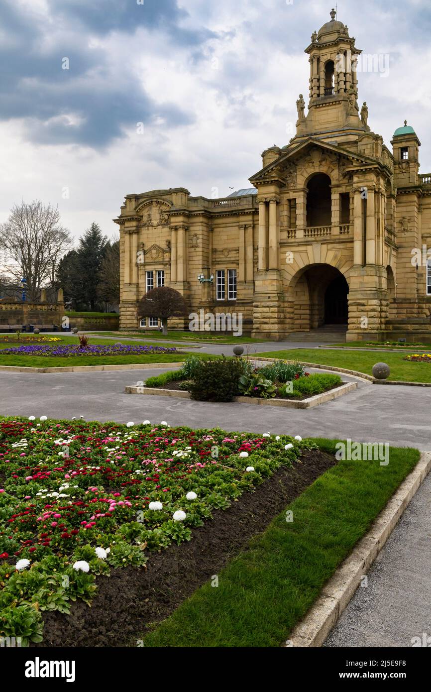 Cartwright Memorial Hall civic art gallery exterior (grand historic building) & bright flowers on beds - scenic Lister Park, Bradford, England, UK. Stock Photo