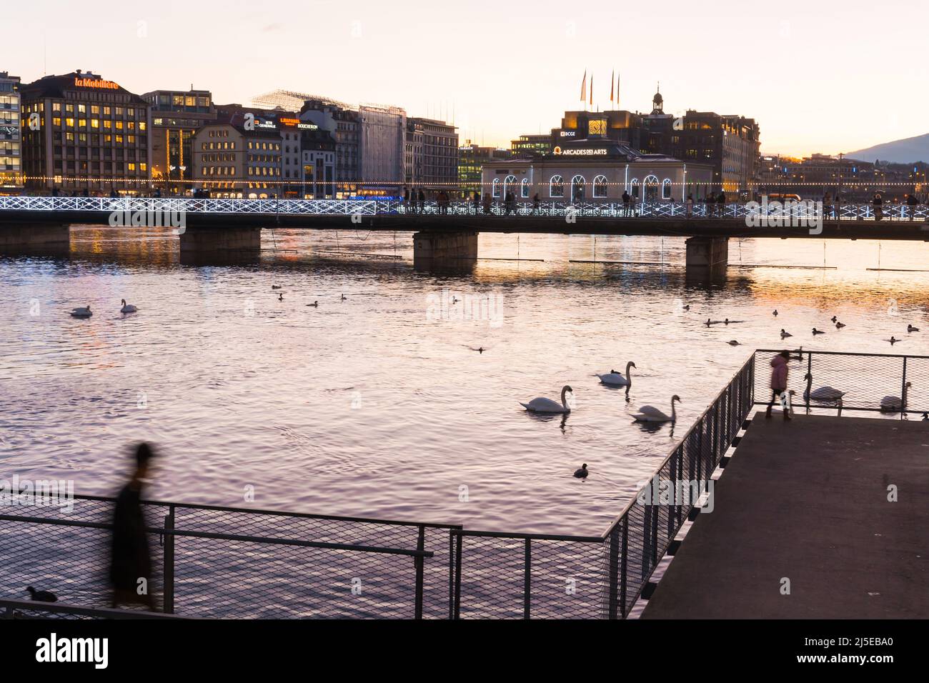 Geneve. Switzerland - December 30, 2021: Sunset over Geneva. Embankment of leman River Stock Photo