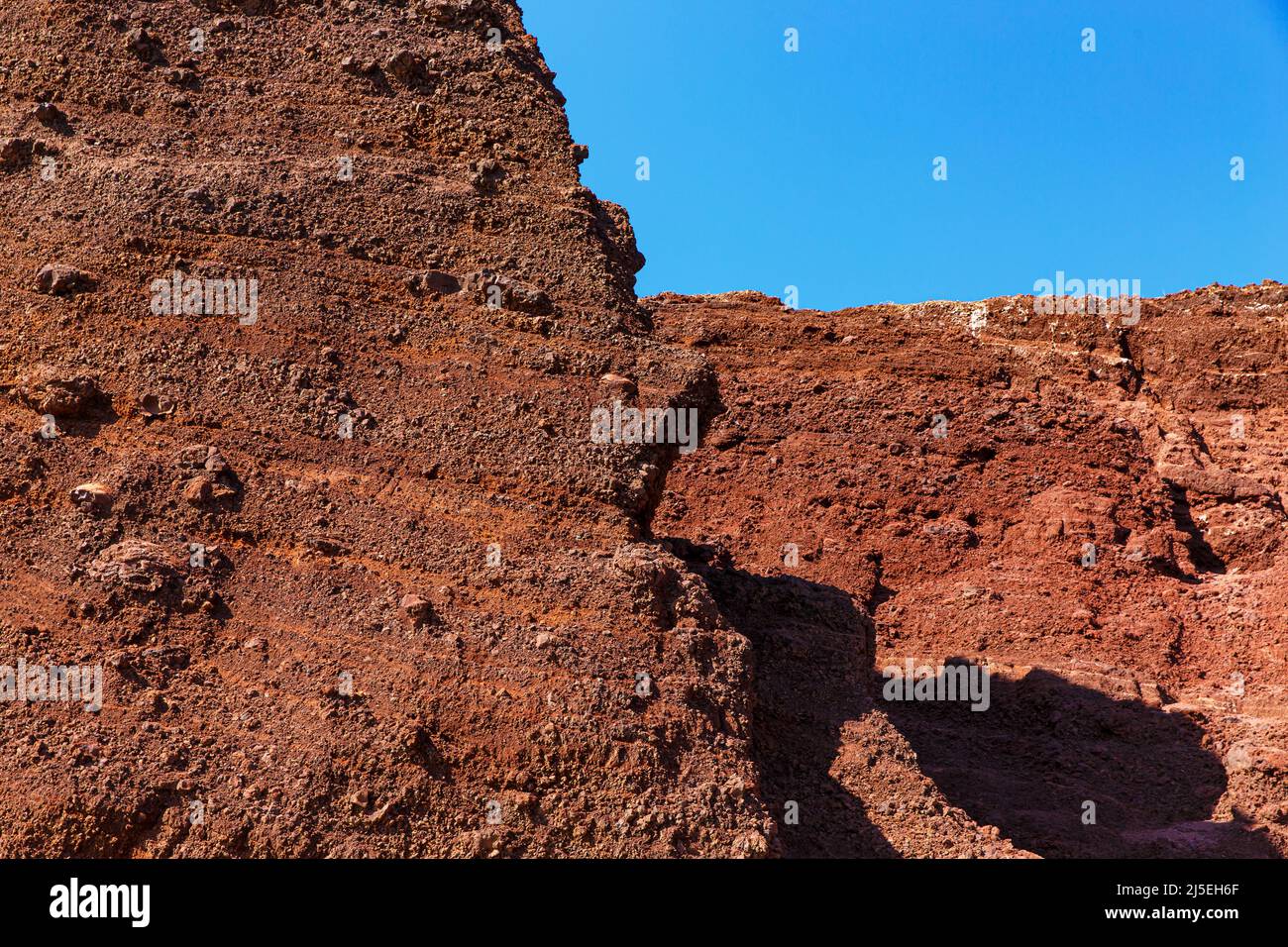 Underneath Red Rocks Red rocks texture under blue sky Stock Photo - Alamy