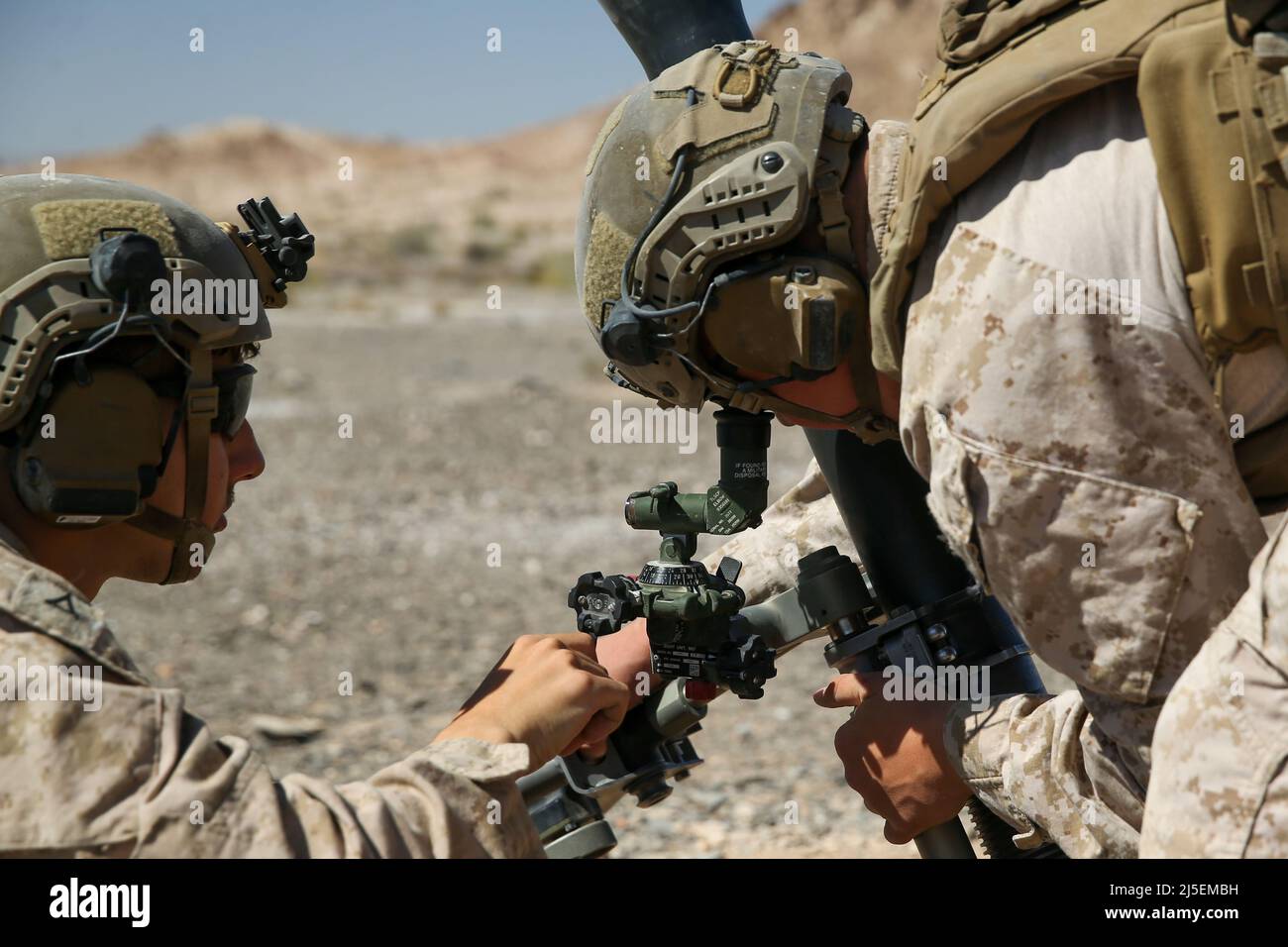U.S. Marine Corps Lance Cpl. Sied Abderrahmane (right), a native of Houma, Louisiana, and Pfc. Jason Ditzel, a native of Woodbridge, New Jersey, both mortarman with 1st Battalion, 2d Marine Regiment, 2d Marine Division (MARDIV), adjust an 81mm mortar on a target during Weapons and Tactics Instructor (WTI) course 2-22 on U.S. Army Yuma Proving Ground, Arizona, April 13, 2022. WTI is a seven-week training event, hosted by Marine Aviation Weapons and Tactics Squadron One, which emphasizes the development of small task-organized unit experimentation across all warfighting functions, as well as enh Stock Photo