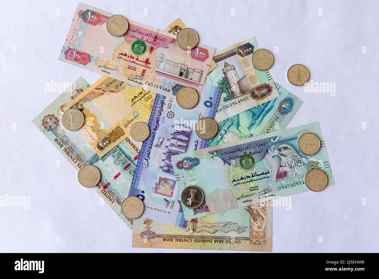 UAE banknotes with coins on white isolated background Stock Photo