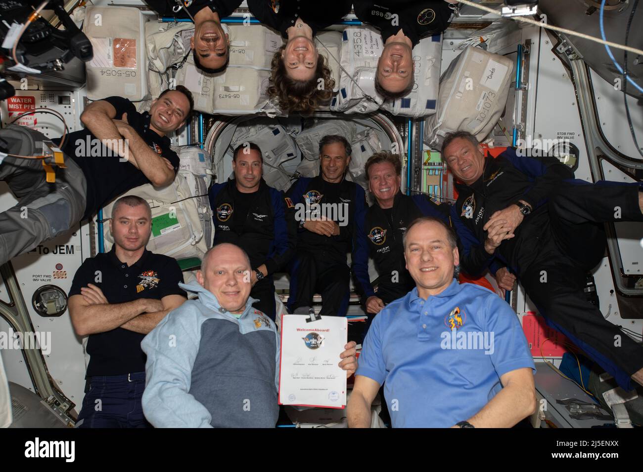 International Space Station, United States of America. 09 April, 2022. The eleven crew members aboard the International Space Station pose for a group photo after the Axiom Mission One crew arrived aboard the SpaceX Crew Dragon Endeavour, April 9, 2022 in Earth Orbit. Clockwise from bottom right:  Expedition 67 Commander Tom Marshburn, Flight Engineers Oleg Artemyev, Denis Matveev, Sergey Korsakov, Raja Chari, Kayla Barron, and Matthias Maurer; and Axiom astronauts (center row from left) Mark Pathy, Eytan Stibbe, Larry Conner, and Michael Lopez-Alegria. Credit: NASA Photo/NASA/Alamy Live News Stock Photo