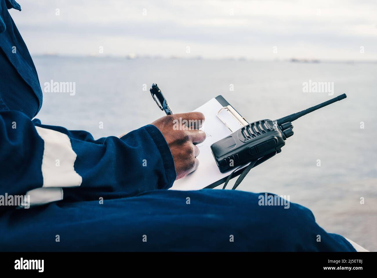 Seaman onboard a ship fills checklist. Paperwork at sea Stock Photo Alamy