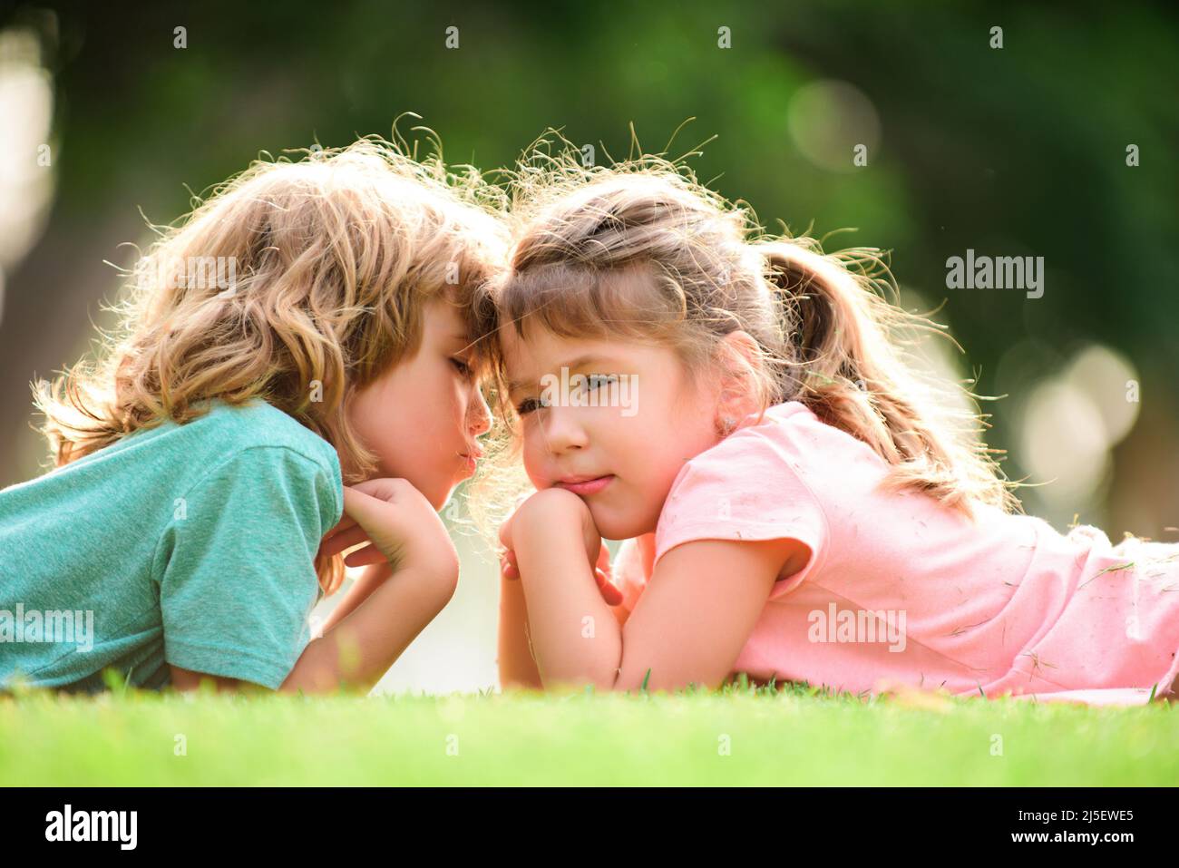 Little boy and girl in love. Cheerful kids playing on park ...