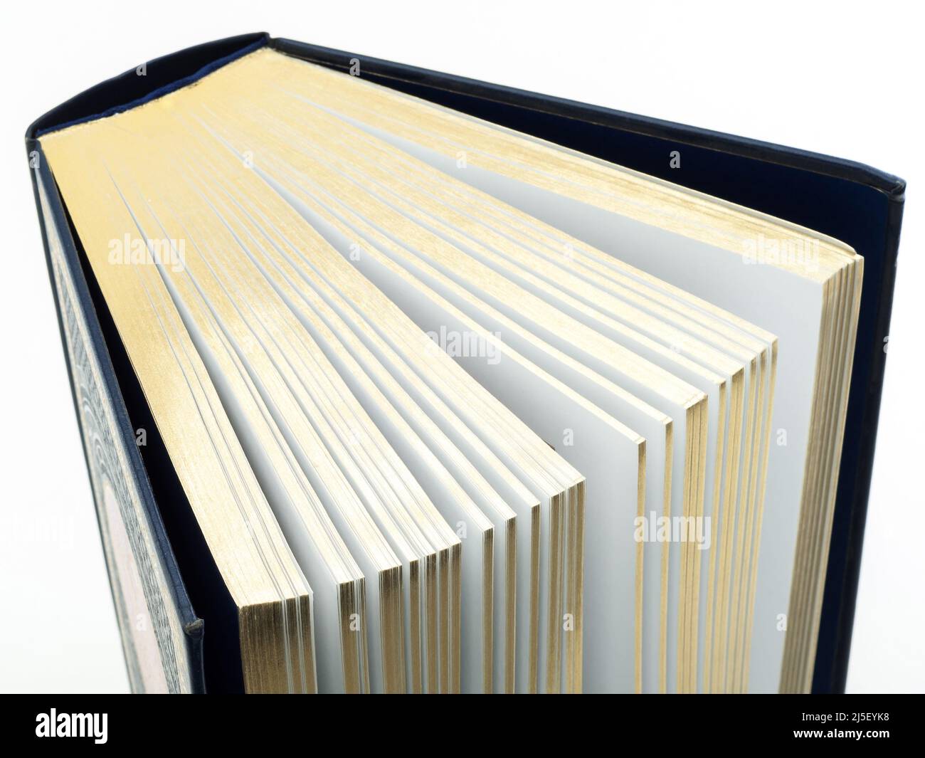 Thick book with gilded pages on white background Stock Photo - Alamy