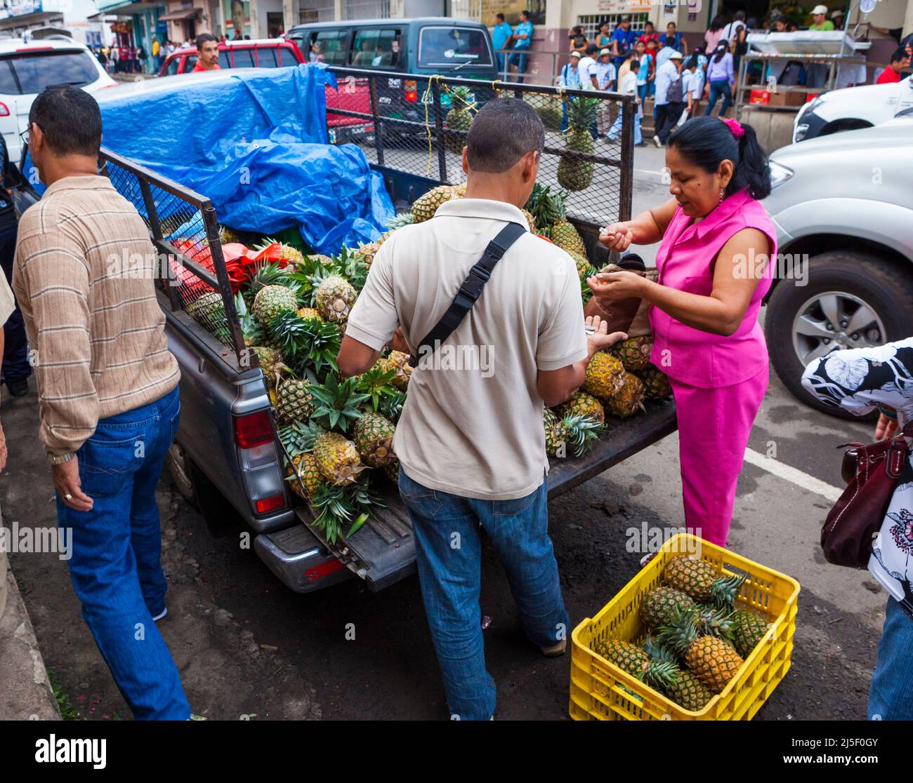 A panamanian woman is buying pineapples from a man at the marketplace in Penonome, Cocle province, Republic of Panama, Central America. Stock Photo