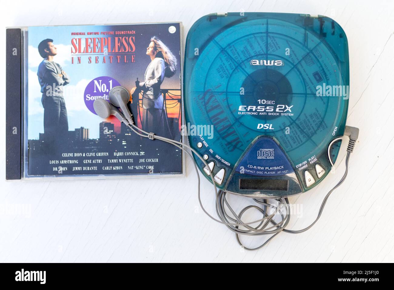 retro vintage Aiwa walkman which is used and old next to a CD of Sleepless in Seattle concept mobile music equipment Stock Photo