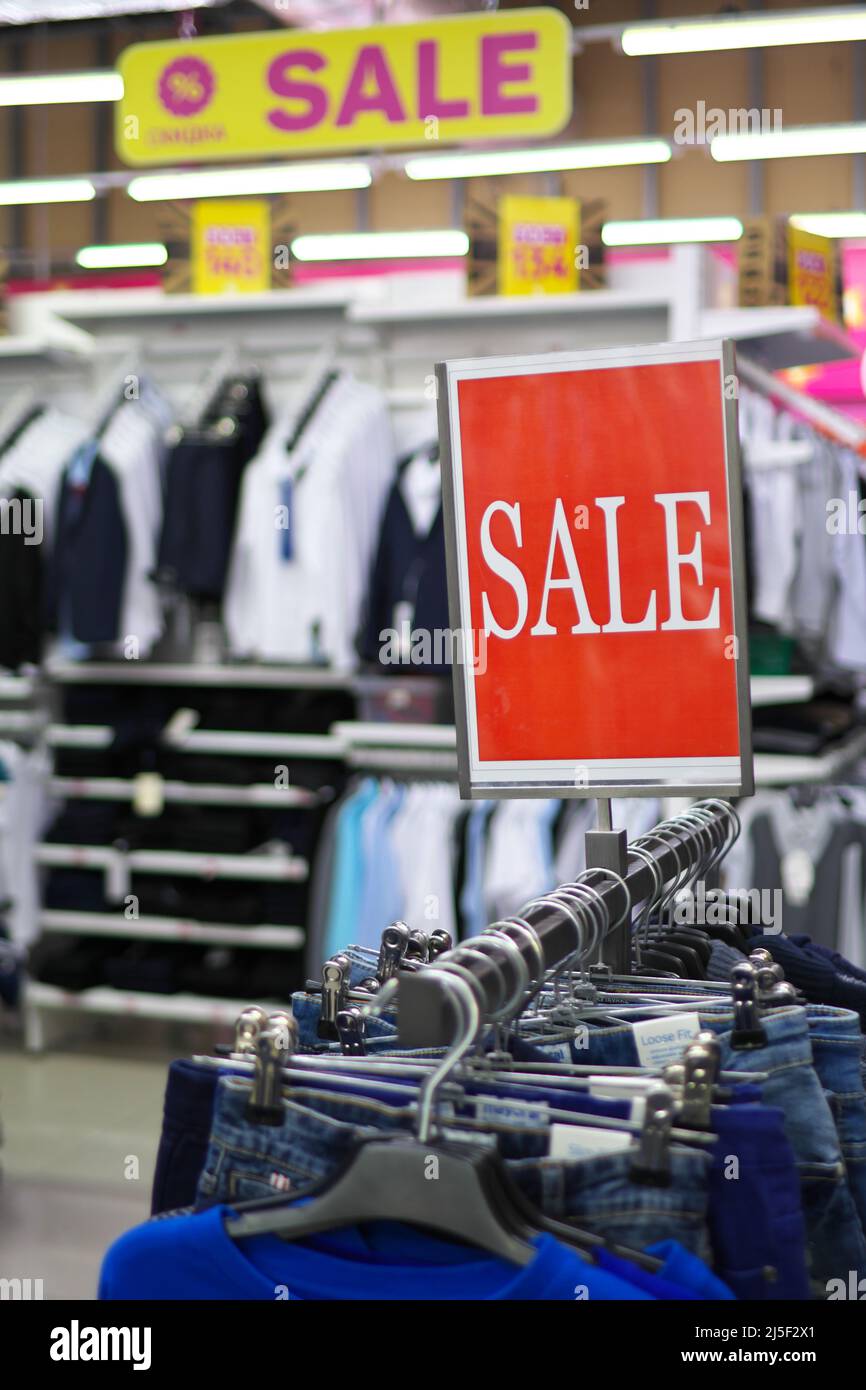 Sale sign notice into a clothes store. Shopping mall advertisement