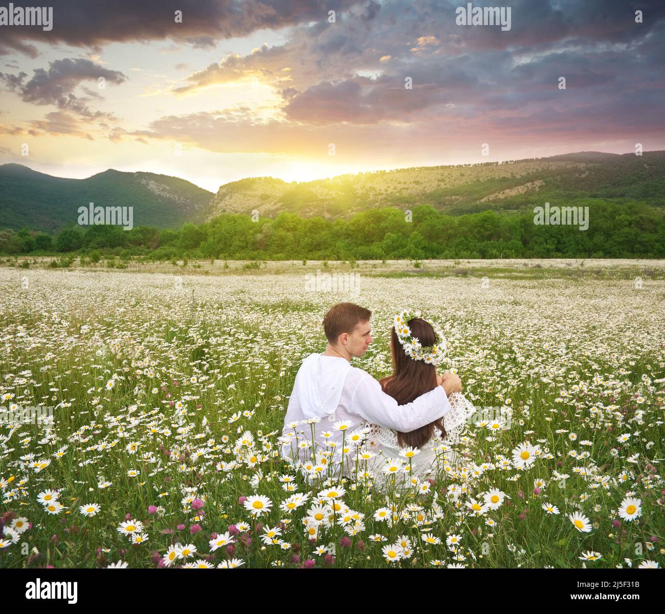 Lovely couple in daisy meadow. Nature and romantic scene Stock Photo ...
