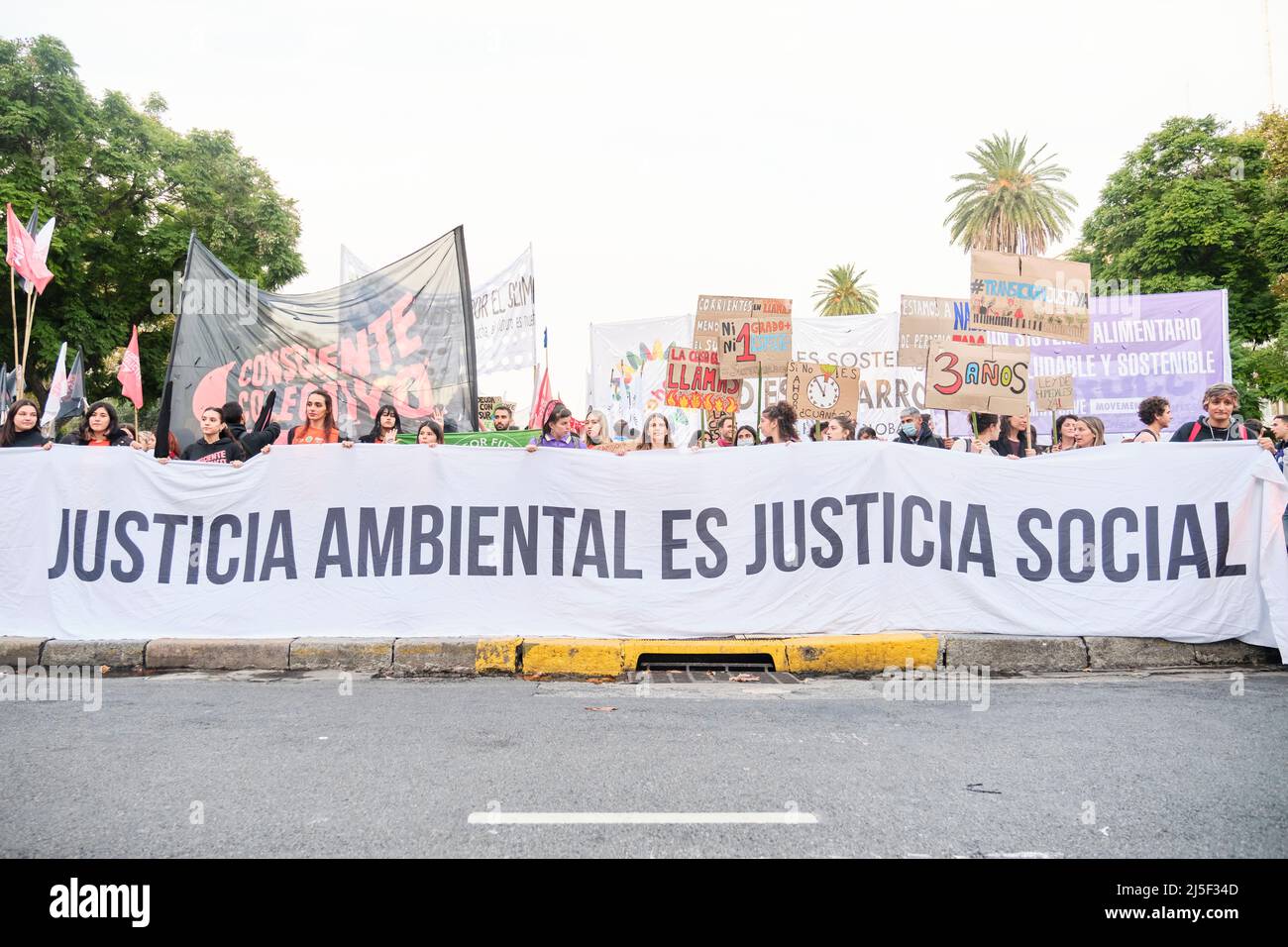 Buenos Aires, Argentina; April 22, 2022: Environmentalism, group of activists raising posters and holding a banner with the text Environmental justice Stock Photo