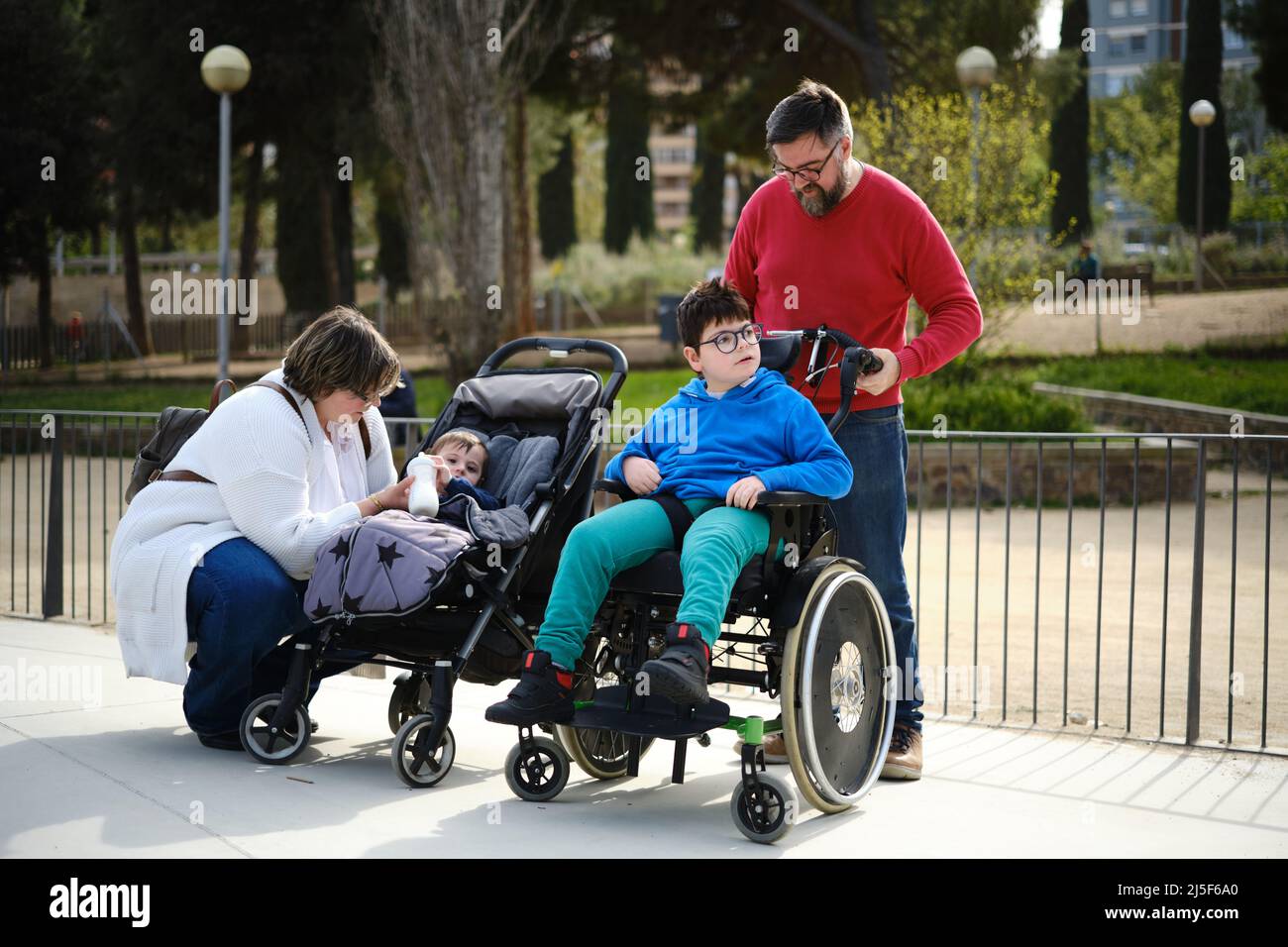 Mother and father enjoying a family day in the park with their baby and