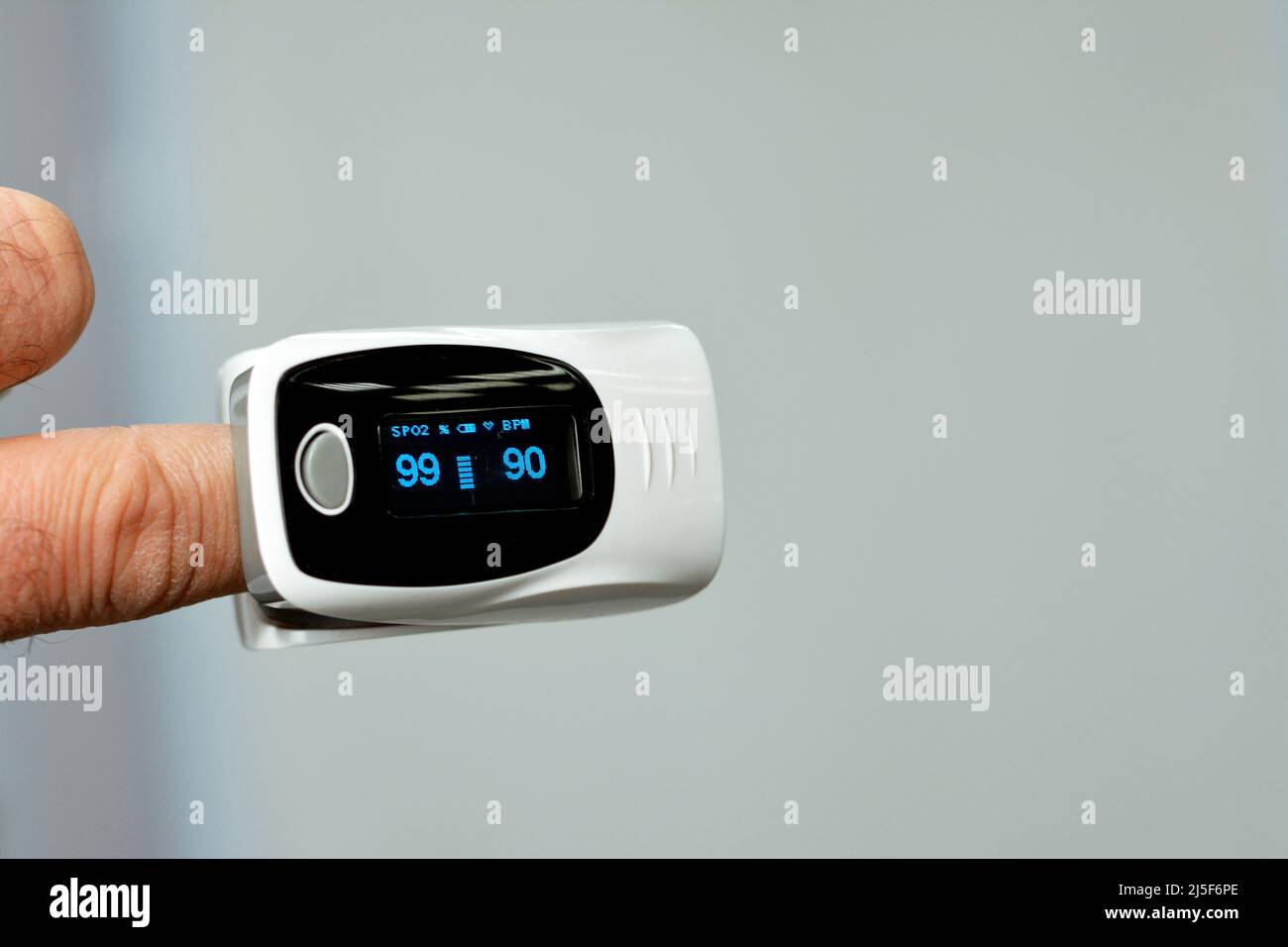 fingertip pulse oximeter equipment connected to the index finger of a ...