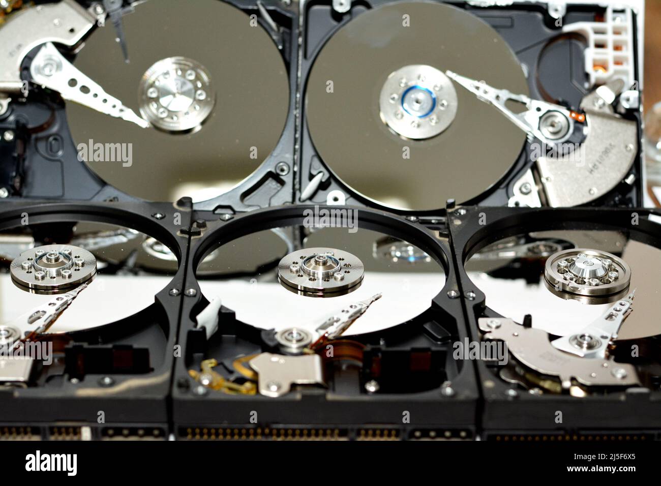Computer hard disk drive storage memory, repair broken computer part, close up of open hard disc with platters, spindle, actuator and read, write head Stock Photo