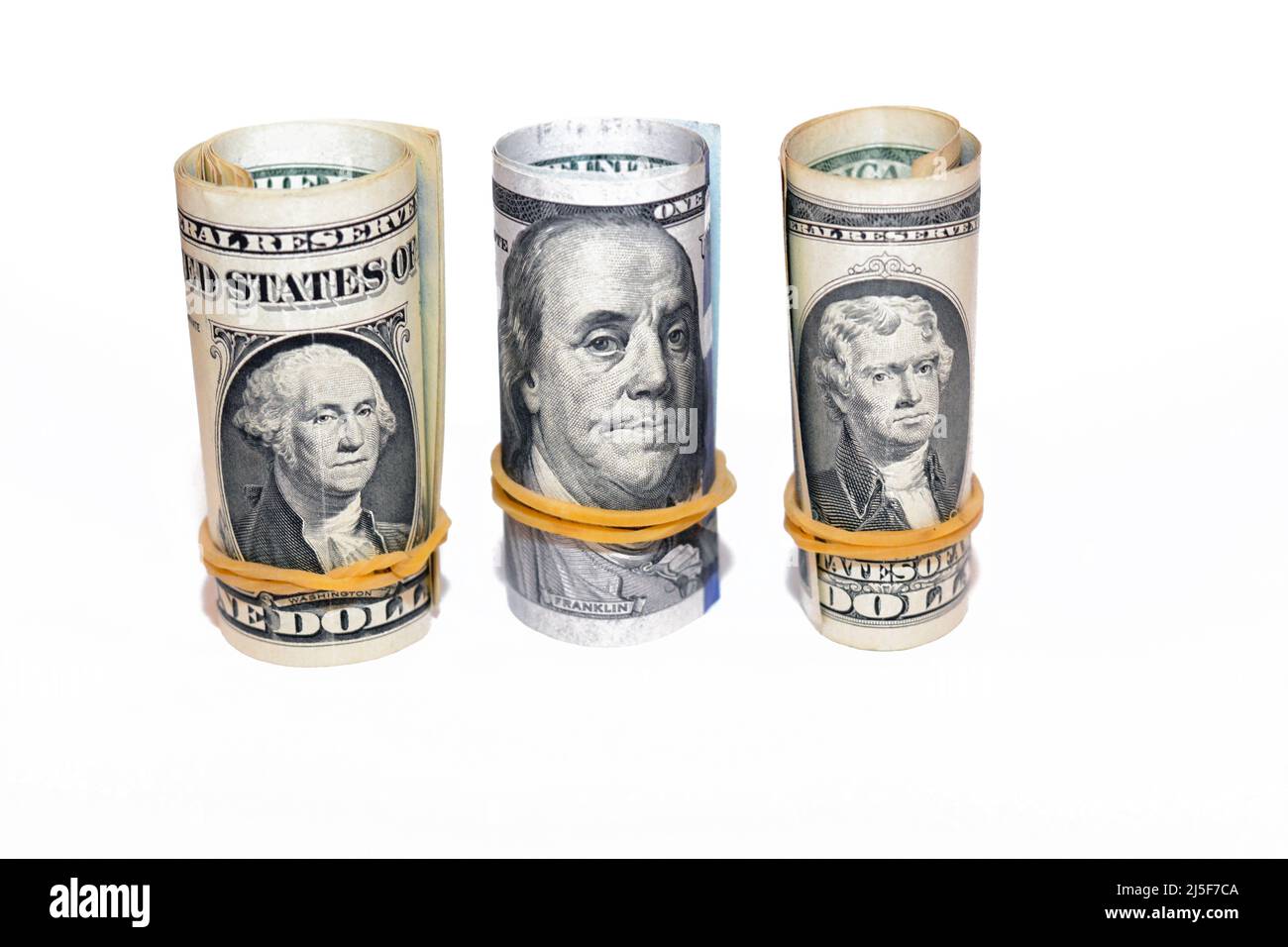 Pile of American dollars rolls isolated on white background, bundles of USA money banknotes rolled up with rubber bands in a raw of 1, 2 and 100 $, on Stock Photo