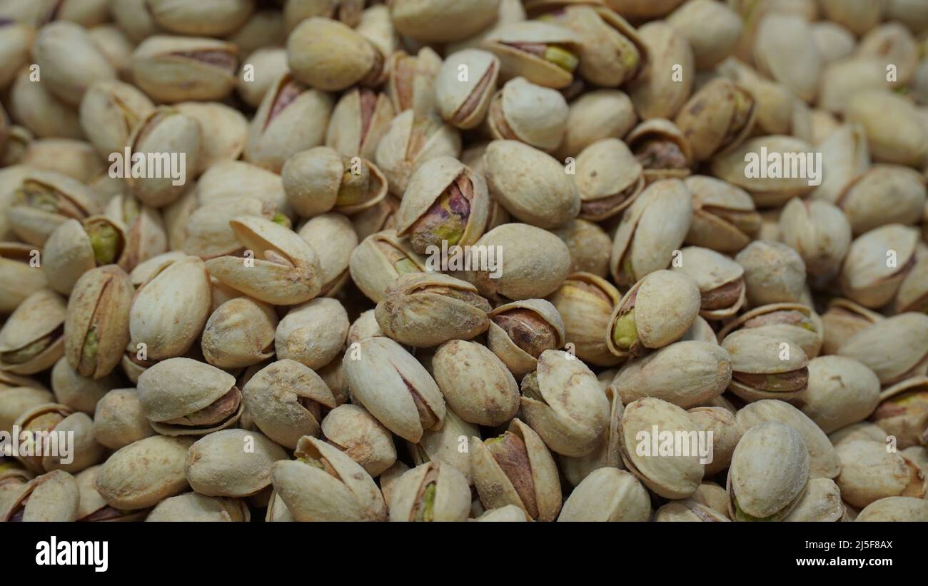 Pistachio Nuts, pistacia vera, Dry Fruits. Closeup pile of beans it