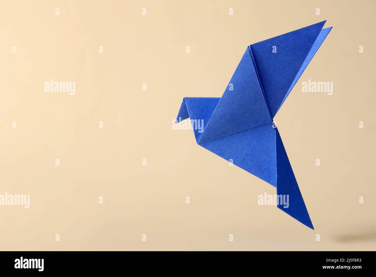 Pigeon flying minimal concept of japanese origami craft handmade toy. Stock Photo
