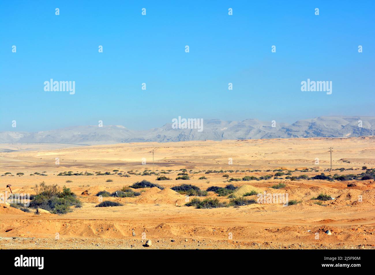 The Eastern desert of Egypt with mountains, sand and the sky, Selective focus of Sinai desert with chains of mountains and hills near Suez road and ci Stock Photo