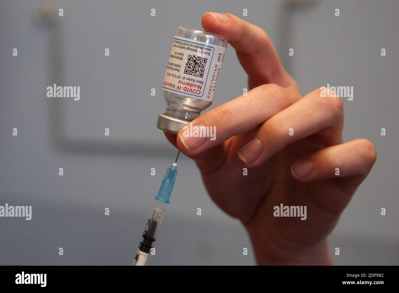 London, UK 22 Apr 2022 - A vaccinator draws the Spikevax (Moderna) COVID-19 vaccine as she prepares to administer the spring booster jab to a person at a vaccination centre. Credit Dinendra Haria /Alamy Live News Stock Photo