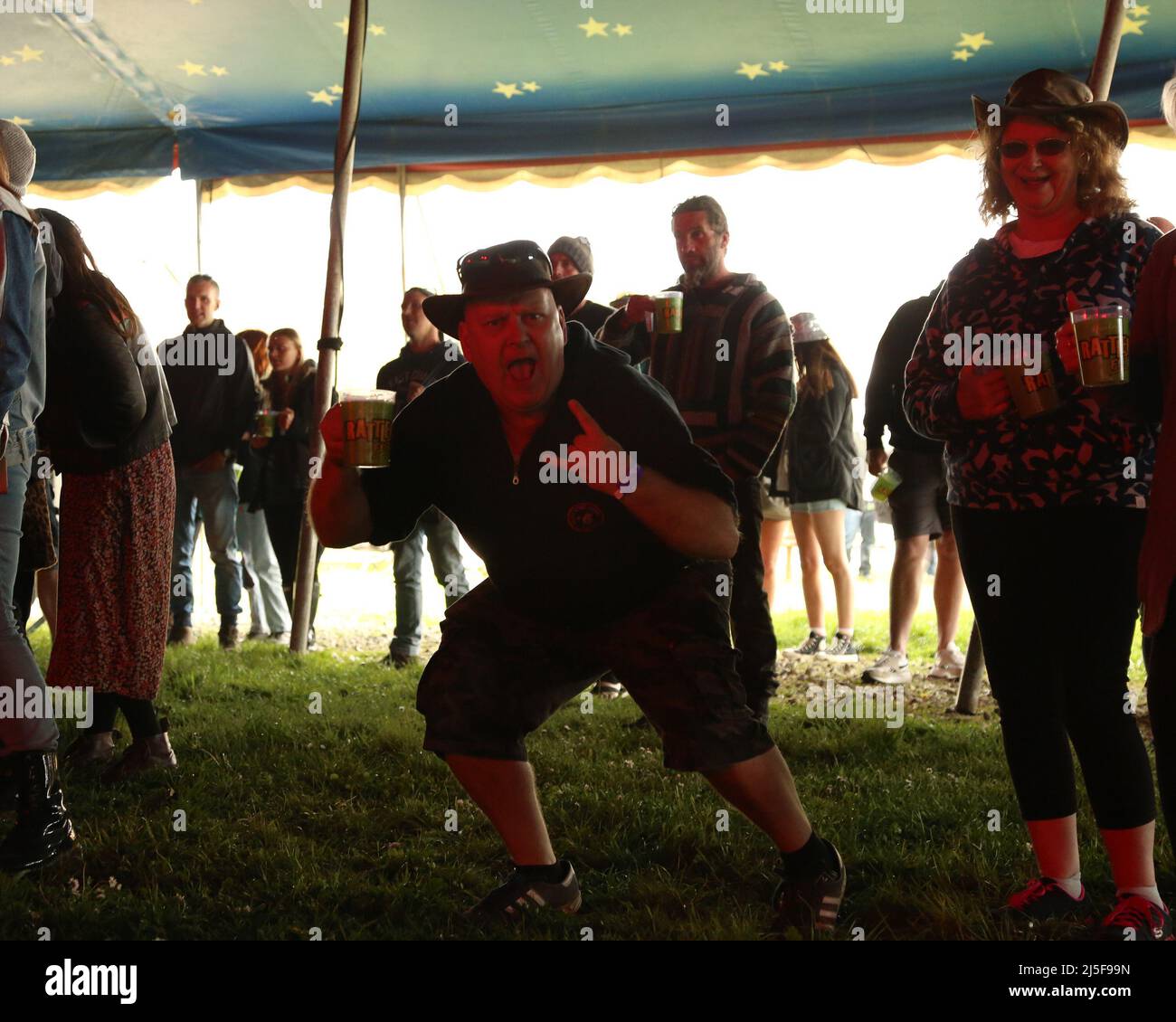22nd April 2022, Penhallow, Truro, UK. A festival goer drinks Rattler