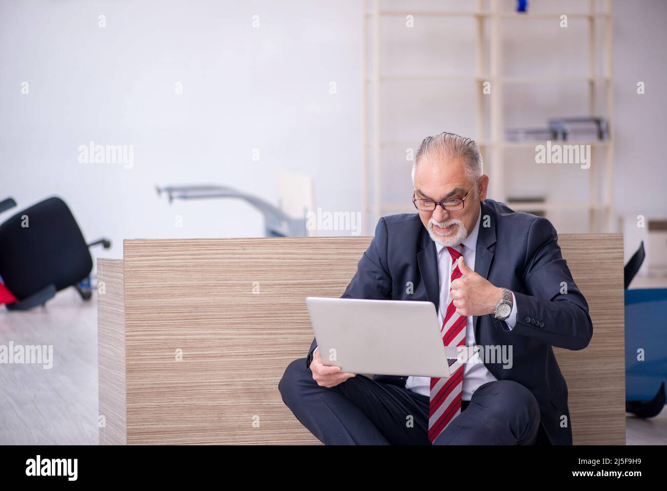 Old businessman employee working overtime at workplace Stock Photo - Alamy
