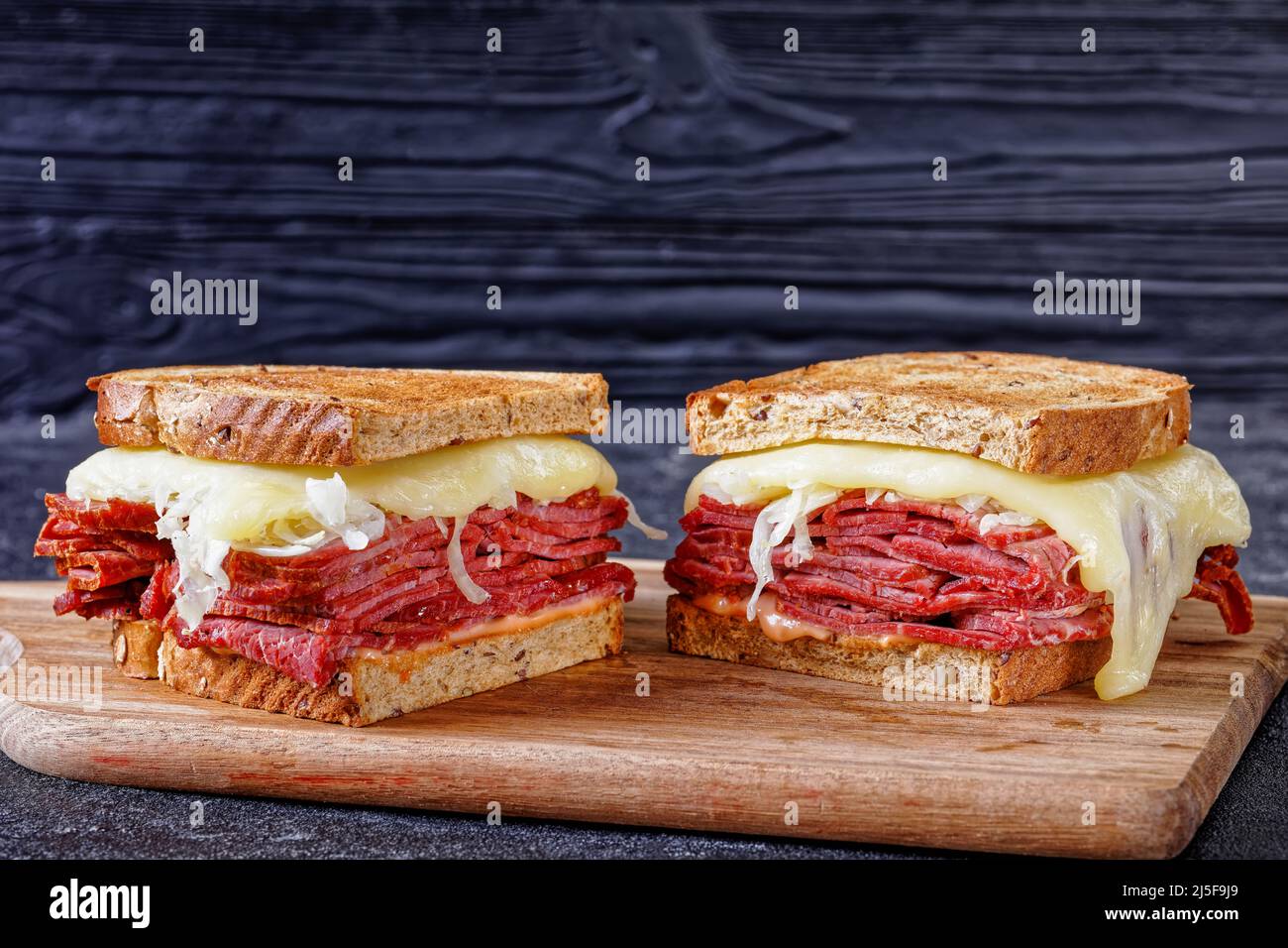 reuben sandwich with rye bread thinly sliced corned beef, sauerkraut, thousand islands sauce and