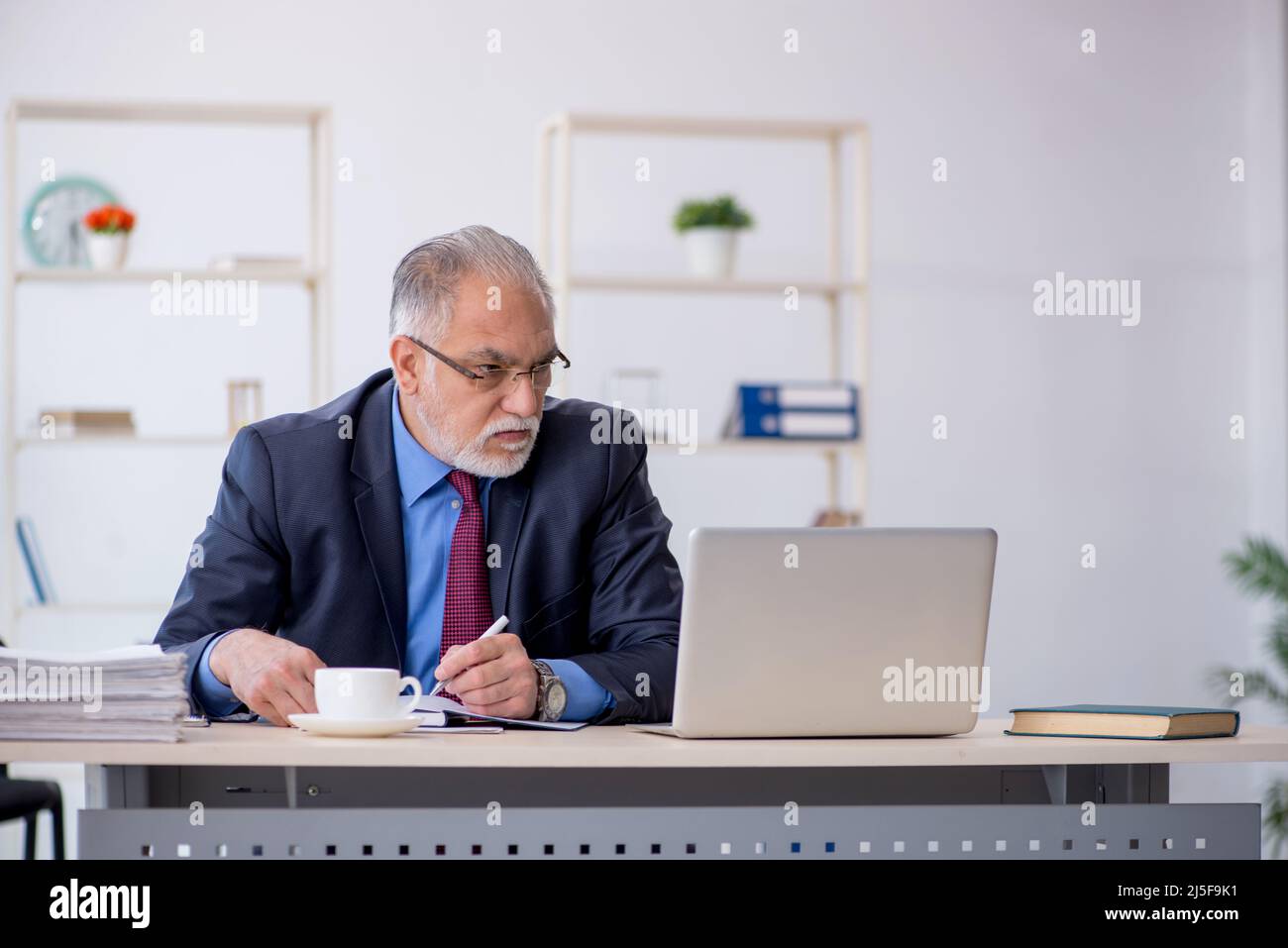 Old businessman employee working at workplace Stock Photo - Alamy