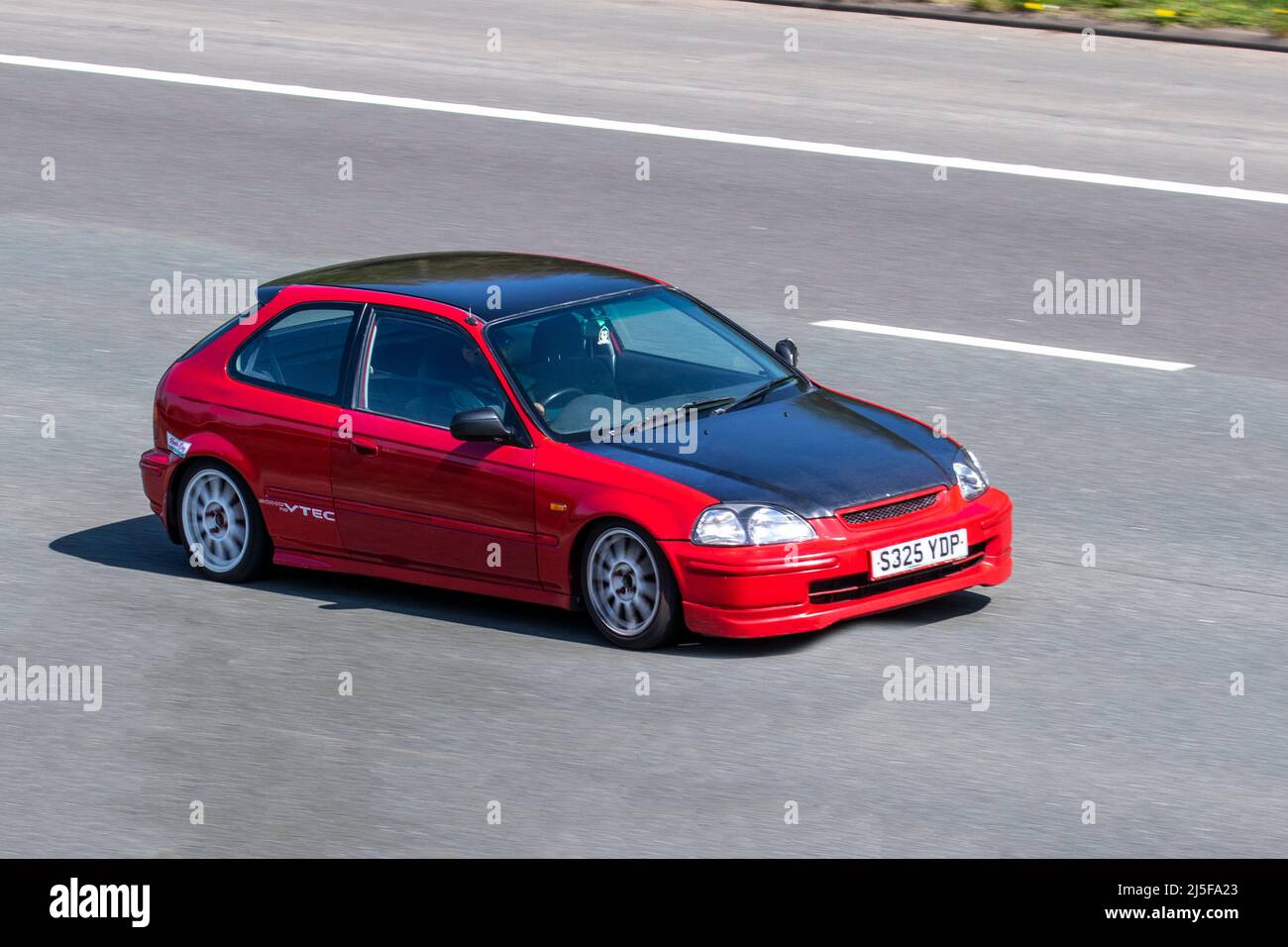 1998 90s nineties red Honda Civic Illusion 1396cc 5 speed manual VTec decals; driving on the M61 motorway, UK Stock Photo