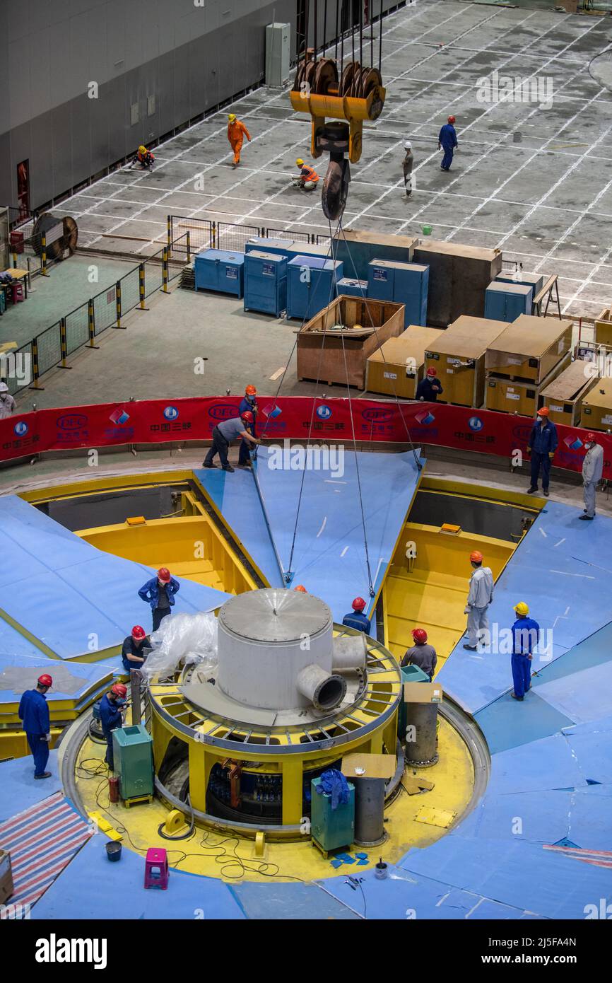 Kunming. 22nd Apr, 2022. Workers assemble a generator of the Baihetan hydropower station in southwest China, April 22, 2022. The Baihetan hydropower station, a major project in China's west-east power transmission program, is located on the Jinsha River, the upper section of the Yangtze River in southwest China. The hydropower station, which straddles the provinces of Yunnan and Sichuan, will have a total installed capacity of 16 million kilowatts. Credit: Hu Chao/Xinhua/Alamy Live News Stock Photo