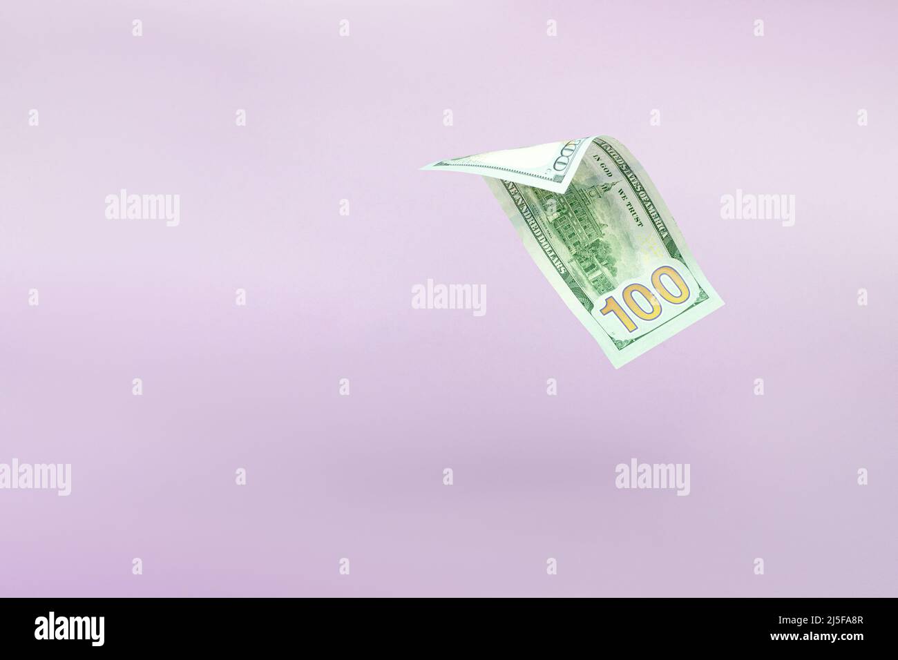 Flying one hundred dollars bills on pastel background. US 100 dollar bill close up. Flying money Stock Photo