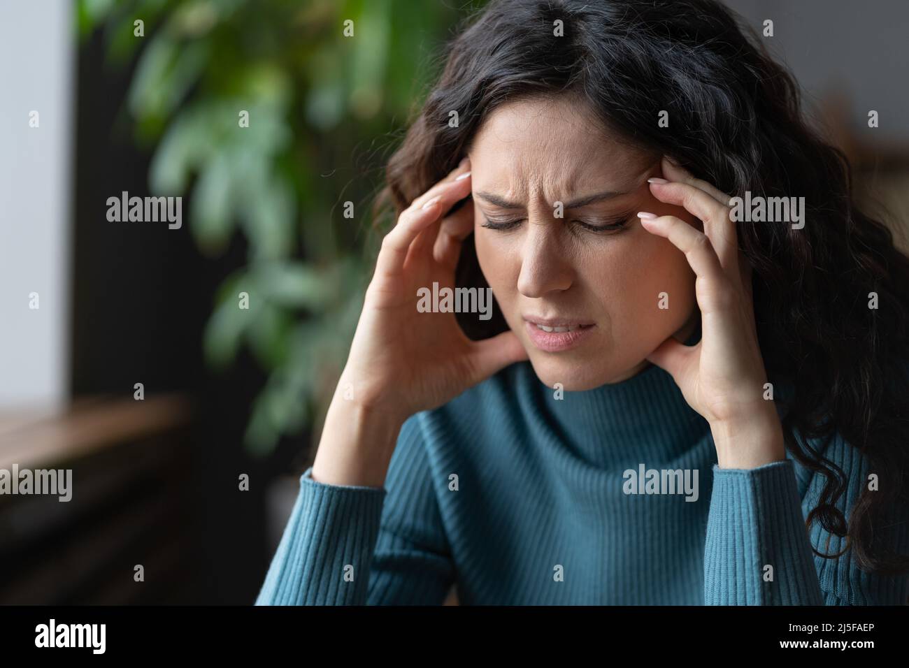 Anxiety disorder. Stressed worried young woman with closed eyes