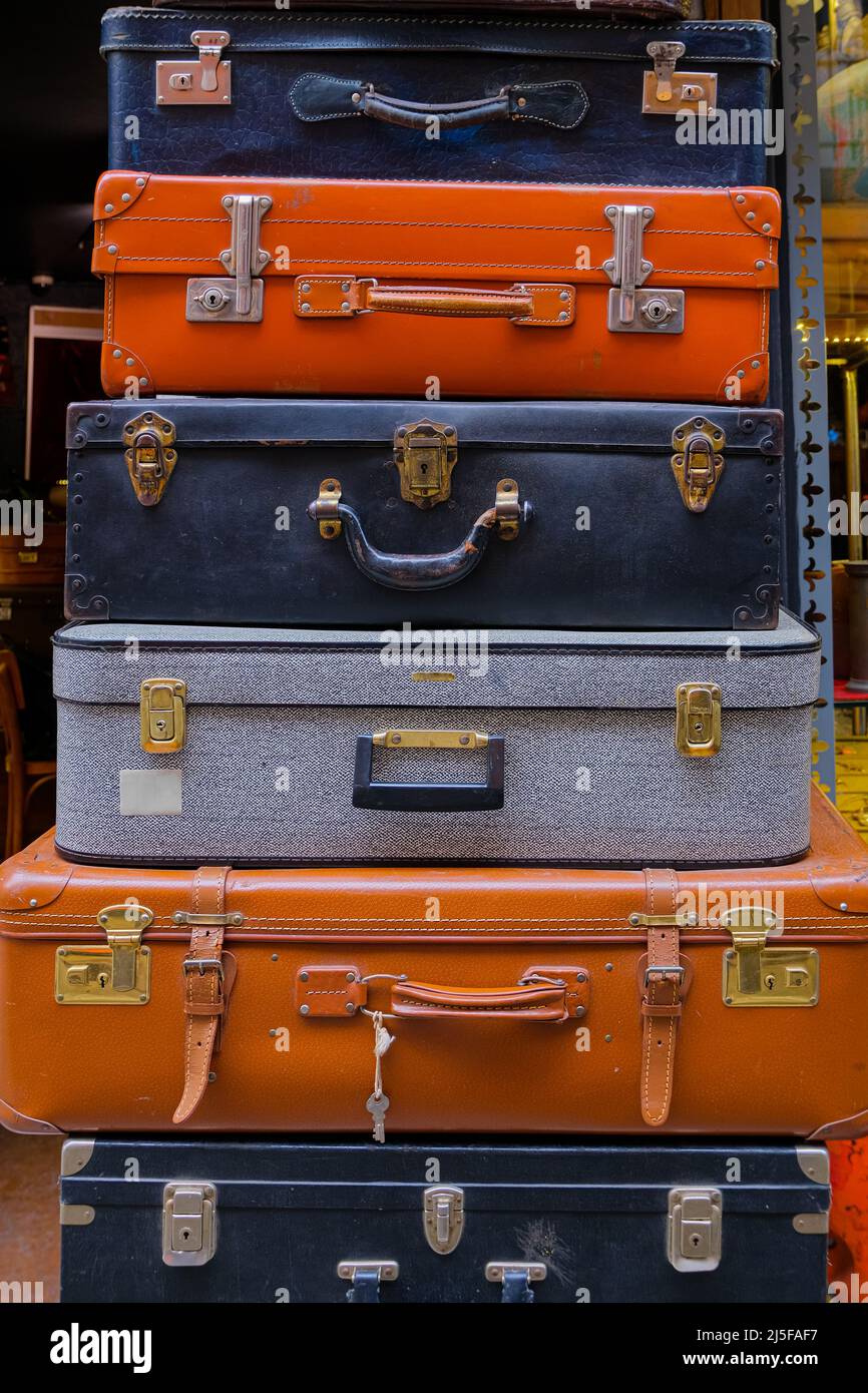 row of old vintage suitcase on a wooden 